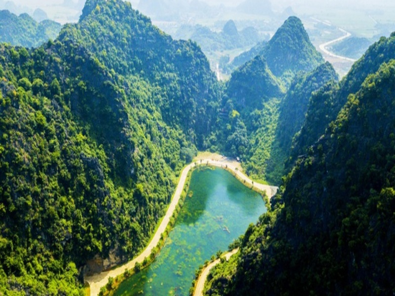Discover Tuyet Tinh Coc's enchanting lake, framed by towering cliffs, blending mystery, tranquility, and quiet isolation