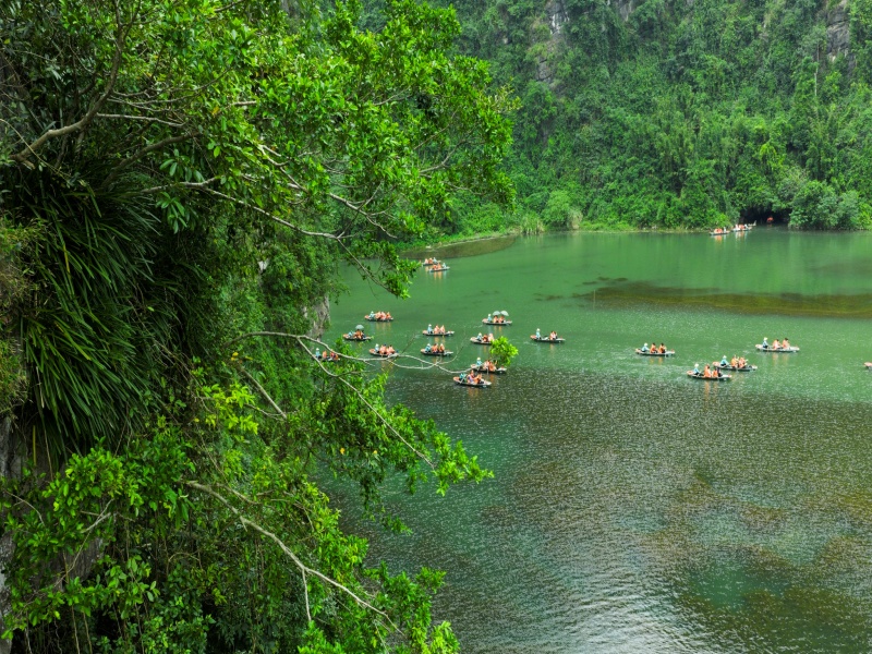 December's cool, dry Ninh Binh: serene boat trips through Trang An/Tam Coc's cliffs, caves.