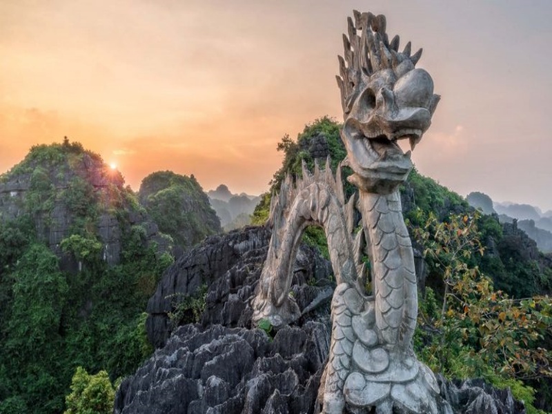 Discover the legendary stone dragon statue perched atop the stunning Mua Cave mountain, a breathtaking sight for visitors