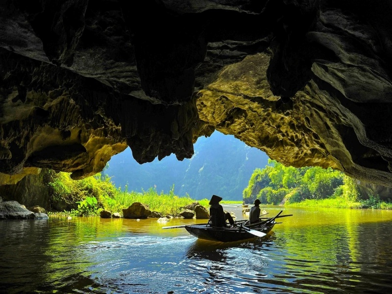 Discover the enchanting three natural caves of Tam Coc on a peaceful sampan boat ride.