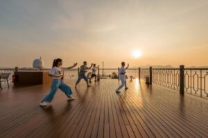 Explore the onboard activities available on different cruise types in Lan Ha Bay, including kayaking and Tai Chi